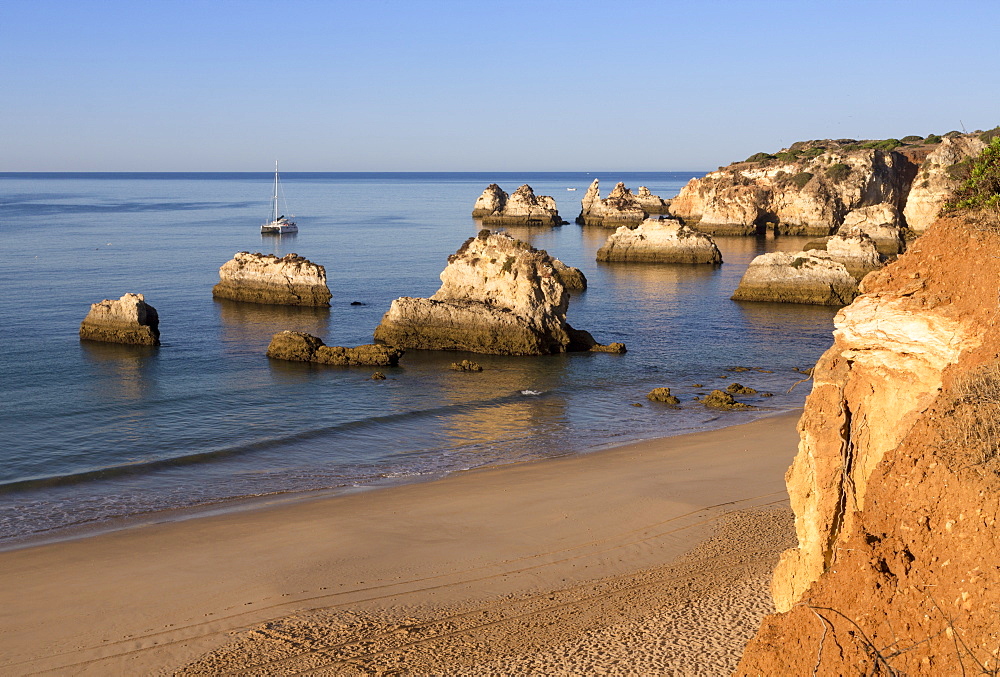 View of the fine sandy beach bathed by the blue ocean at dawn, Praia do Alemao, Portimao, Faro district, Algarve, Portugal, Europe