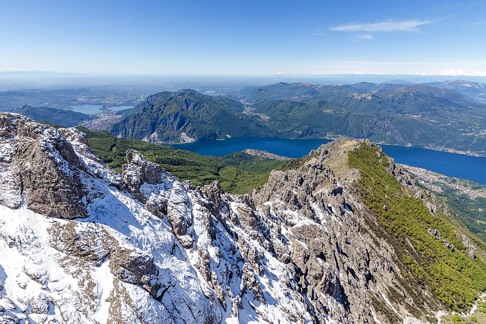 Aerial view of the snowy ridges of the Grignetta mountain with Lake Como in the background, Lecco Province, Lombardy, Italy, Europe