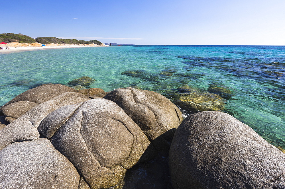 Rocks frame the turquoise water of sea around the sandy beach of Sant Elmo Castiadas, Costa Rei, Cagliari, Sardinia, Italy, Mediterranean, Europe