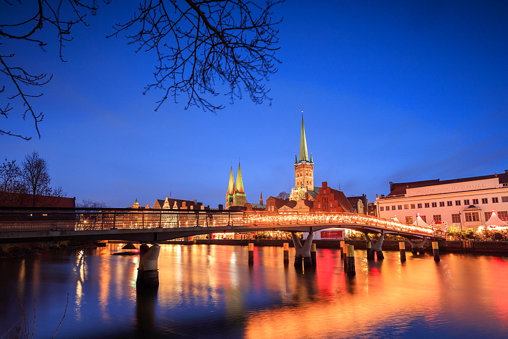 The lights of dusk on typical bridge and the cathedral reflected in River Trave, Lubeck, Schleswig Holstein, Germany, Europe