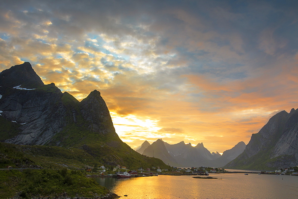 Sunset on the fishing village surrounded by rocky peaks and sea, Reine, Nordland county, Lofoten Islands, Arctic, Northern Norway, Scandinavia, Europe