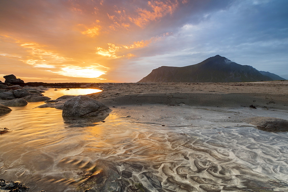 The midnight sun reflected on the sandy beach of Skagsanden, Ramberg, Nordland county, Lofoten Islands, Arctic, Northern Norway, Scandinavia, Europe