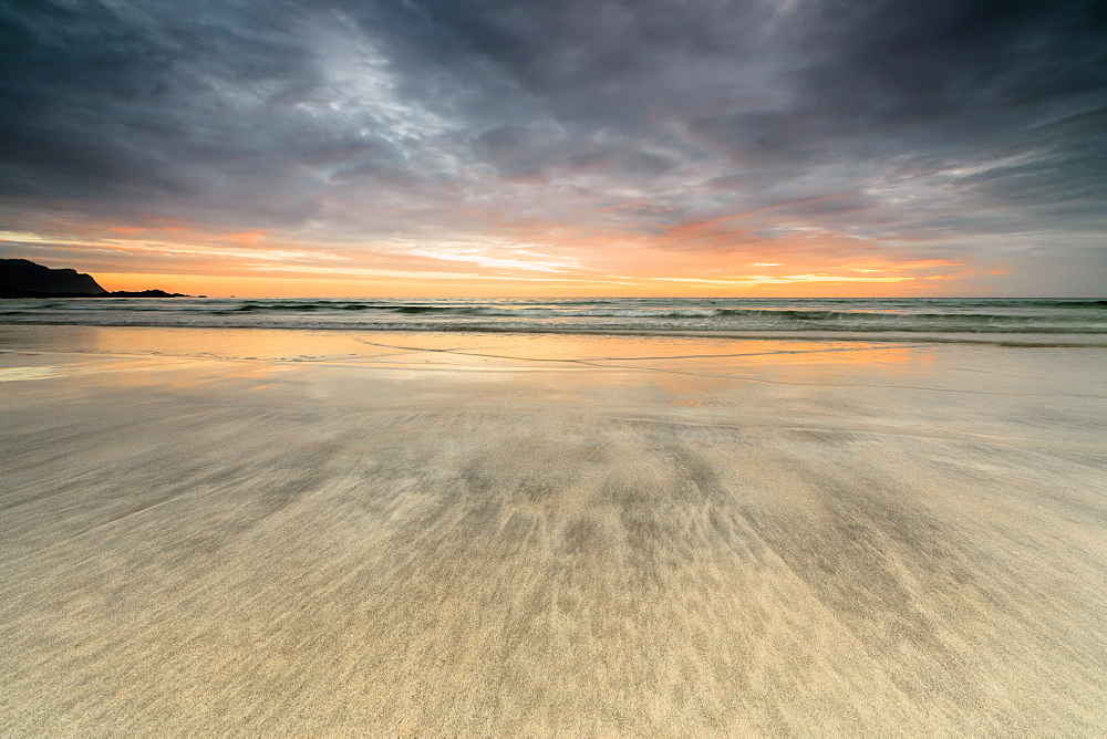 The midnight sun reflected on the sandy beach of Skagsanden, Ramberg, Nordland county, Lofoten Islands, Arctic, Northern Norway, Scandinavia, Europe