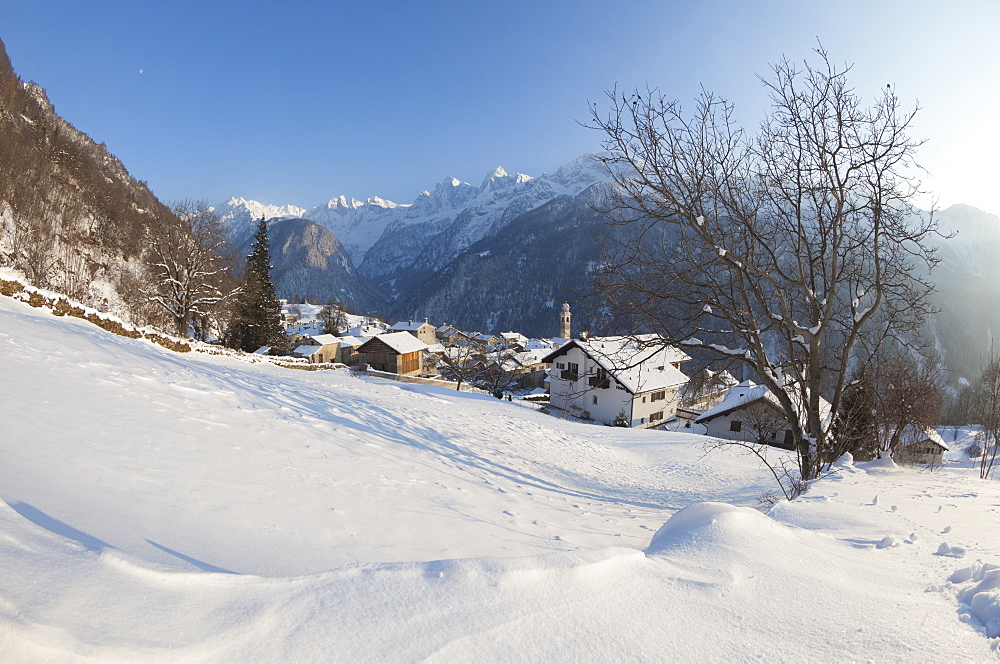 Sunset on the snowy village of Soglio, Maloja District, Bregaglia Valley, Engadine, Canton of Graubunden, Switzerland, Europe