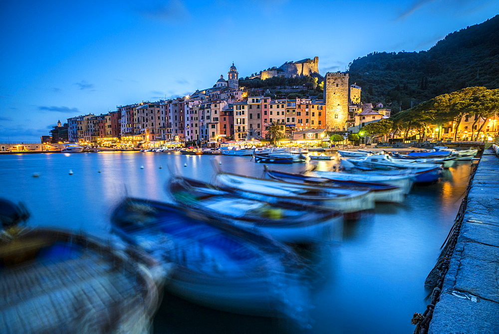 View of blue sea and boats surrounding the colorful village at dusk, Portovenere, UNESCO World Heritage Site, La Spezia Province, Liguria, Italy, Europe