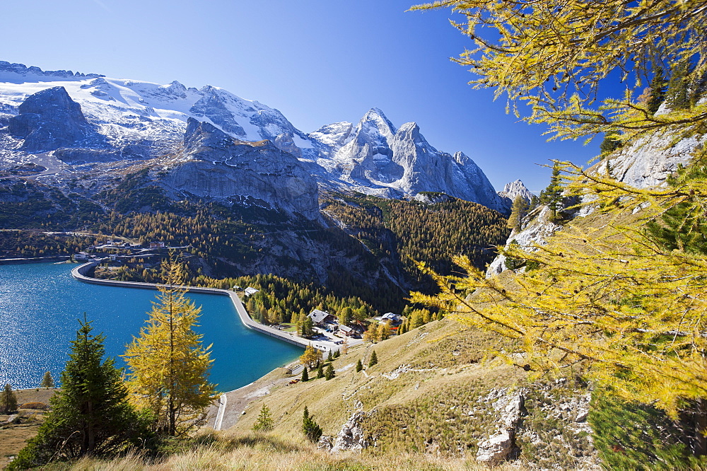 The majestic Marmolada Group and the Lake Fedaia with its turquoise waters, Dolomites, Italy, Europe