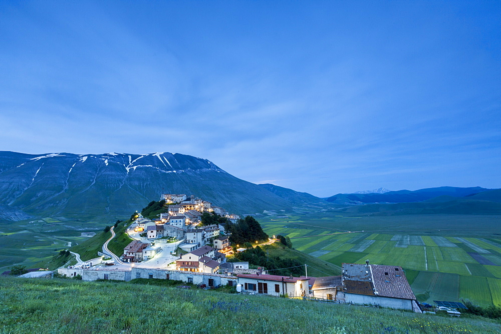 Dusk on the medieval village surrounded by green fields, Castelluccio di Norcia, Province of Perugia, Umbria, Italy, Europe