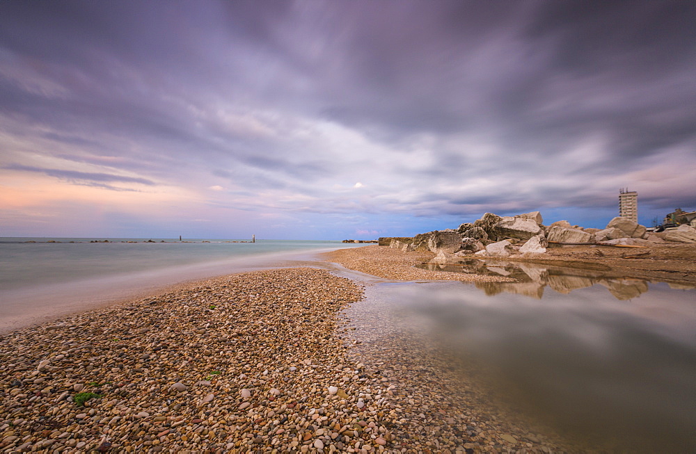 Storm clouds are reflected in the clear water at sunset, Porto Recanati, Province of Macerata, Conero Riviera, Marche, Italy, Europe