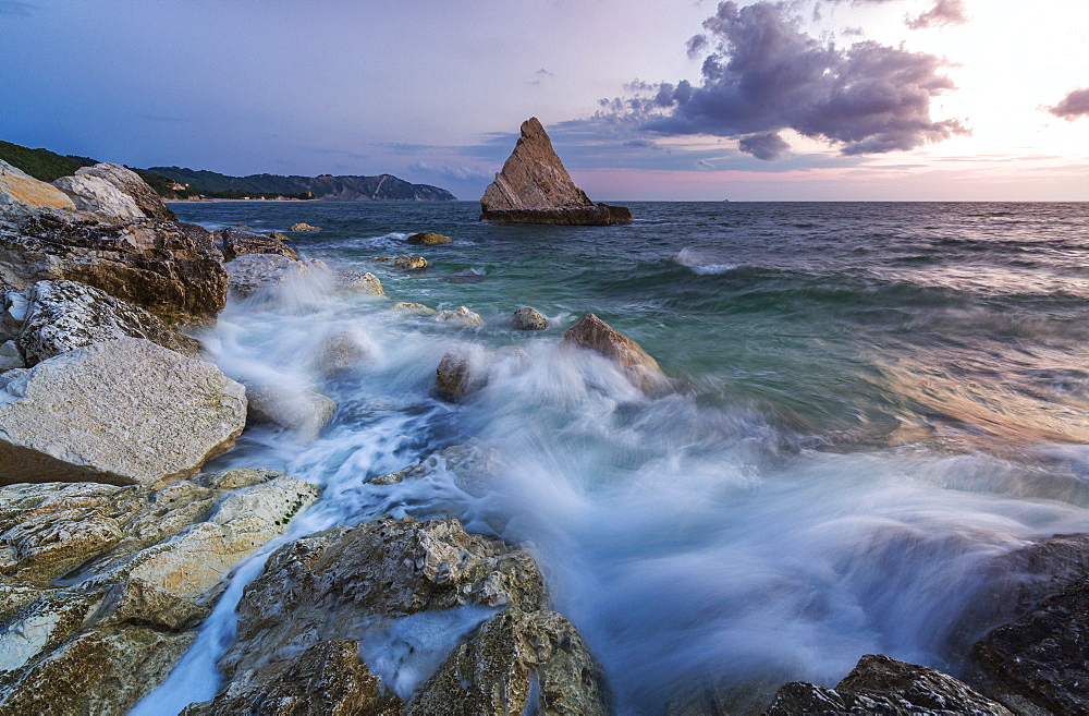 Waves of blue sea framed by the pink sunrise, La Vela Beach, Portonovo, province of Ancona, Conero Riviera, Marche, Italy, Europe