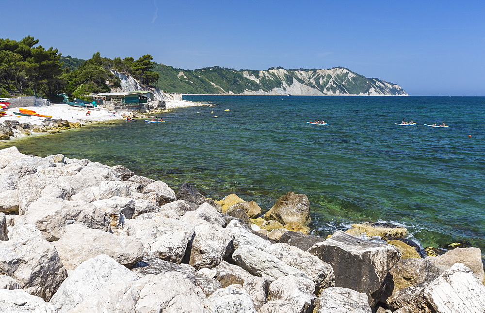 Canoe in the bay surrounded by the turquoise sea, Province of Ancona, Conero Riviera, Marche, Italy, Europe