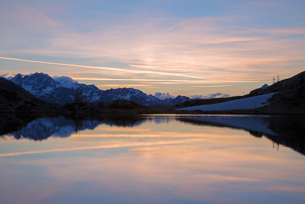 Snowy peaks reflected in Lake Zana at sunrise, Malenco Valley, Valtellina, Province of Sondrio, Lombardy, Italy, Europe