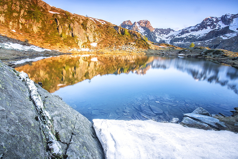 Snowy peaks reflected in Lake Zana at sunrise, Malenco Valley, Valtellina, Province of Sondrio, Lombardy, Italy, Europe