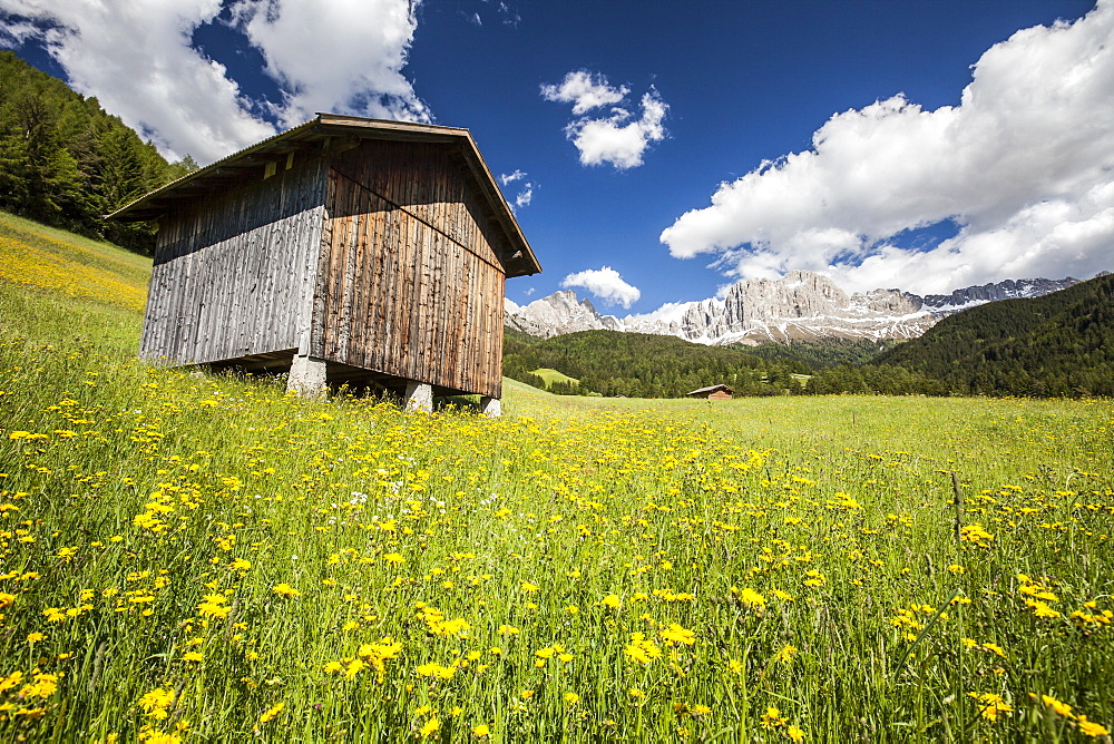 A typical mountain hut in the Tires Valley, by the Catinaccio Group and Lake Carezza in the Dolomites, South Tyrol, Italy, Europe