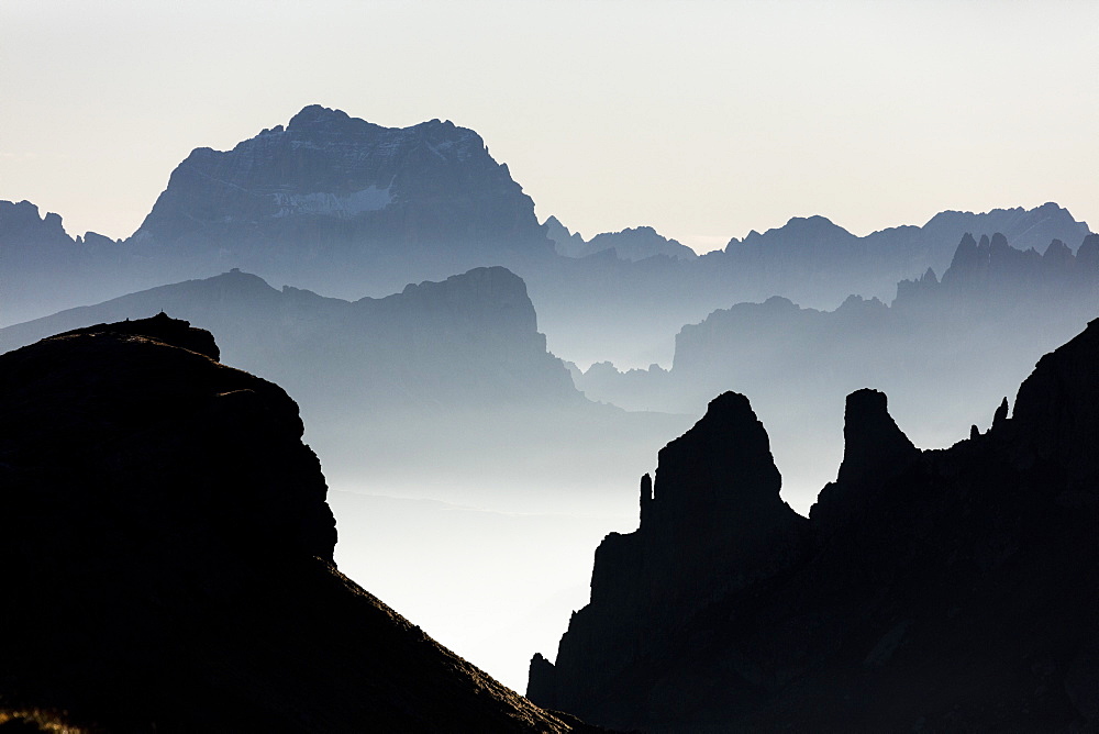 Mist on peaks of Dolomites and Monte Pelmo seen from Cima Belvedere at dawn, Val di Fassa, Trentino-Alto Adige, Italy, Europe