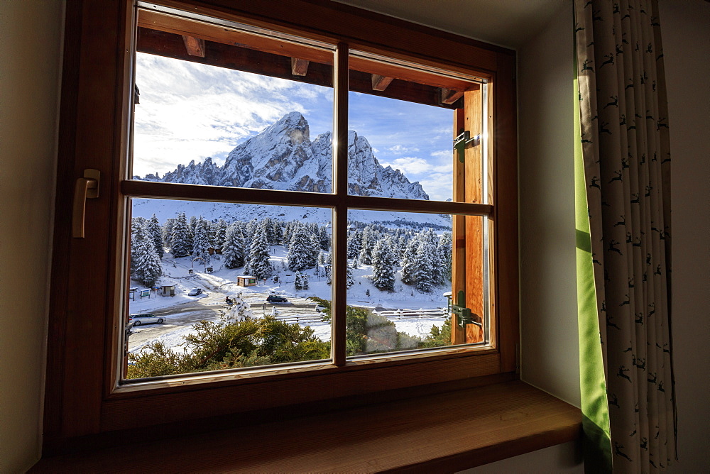 View of Sass De Putia surrounded by snowy woods from the window, Passo Delle Erbe, Funes Valley, South Tyrol, Italy, Europe