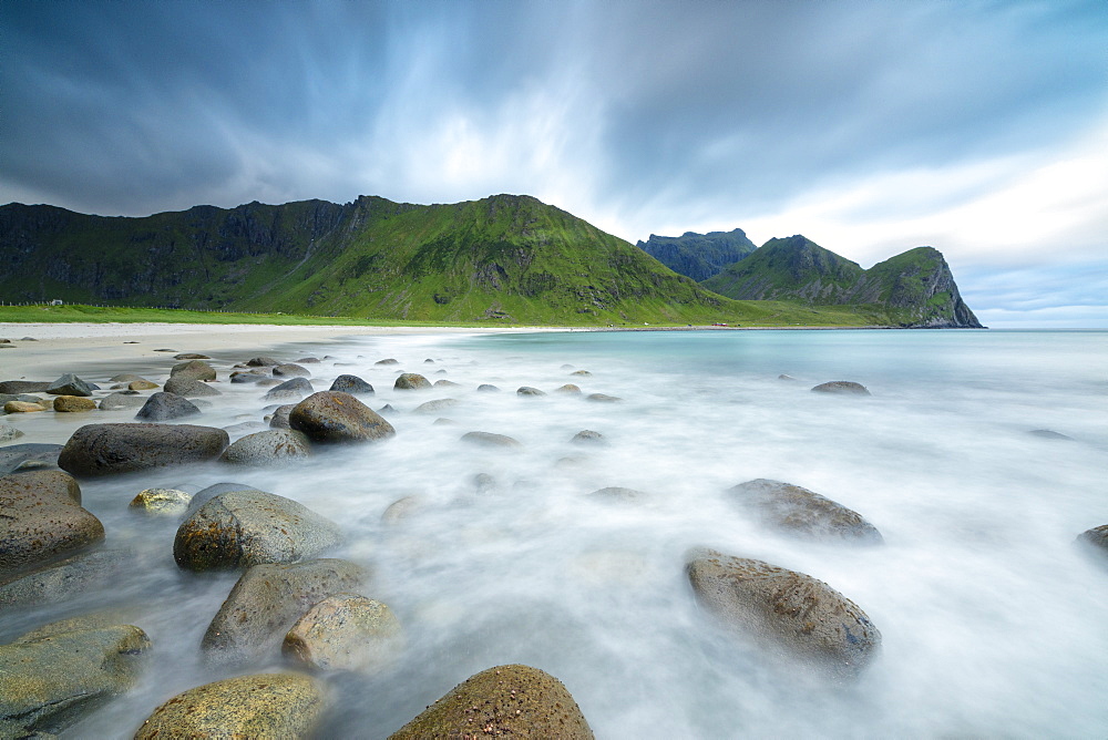 The midnight sun lights up the waves of the blue sea, Unstad, Vestvagoy, Lofoten Islands, Arctic, Norway, Scandinavia, Europe