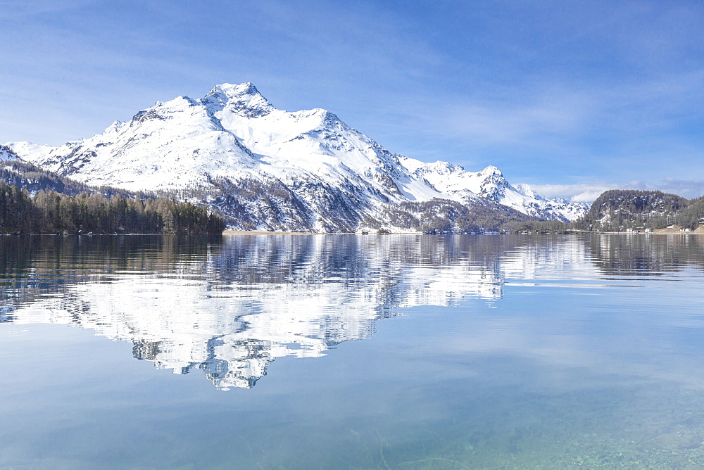 Snowy peaks reflected in the clear water of Lake Sils, Maloja, Canton of Graubunden, Engadine, Switzerland, Europe