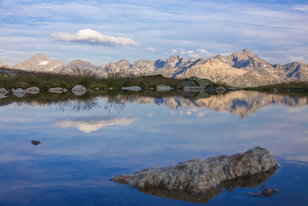 The clear sky is reflected in the blue alpine lake, Muottas Muragl, Samedan, Canton of Graubunden, Engadine, Switzerland, Europe