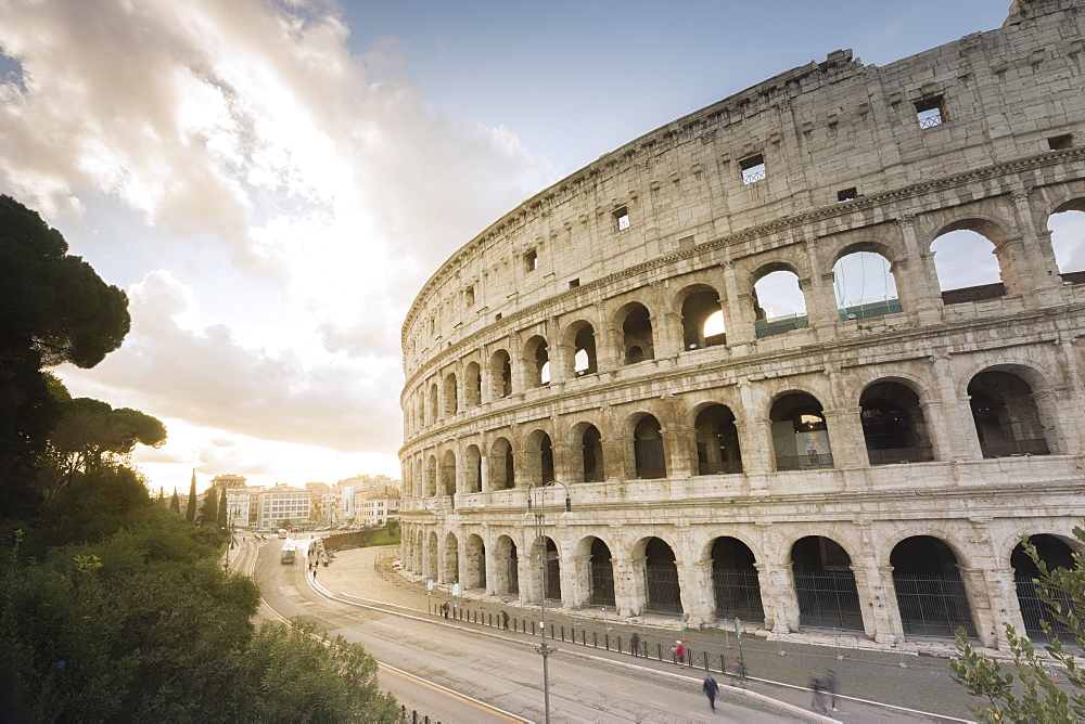 The lights of sunrise frame the ancient Colosseum (Flavian Amphitheatre), UNESCO World Heritage Site, Rome, Lazio, Italy, Europe