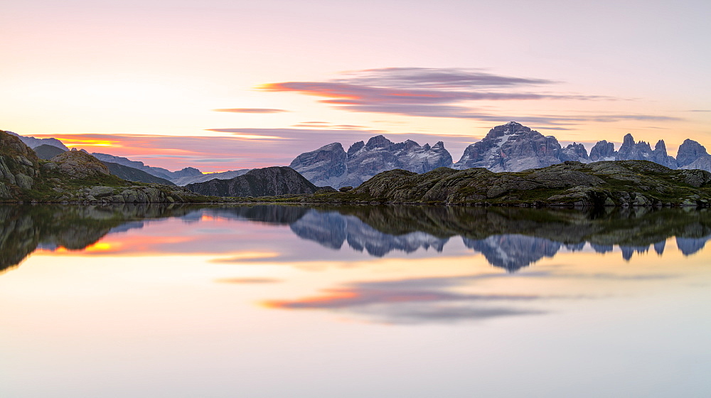 Pink clouds are reflected in Lago Nero at dawn, Cornisello Pinzolo, Brenta Dolomites, Trentino-Alto Adige, Italy, Europe