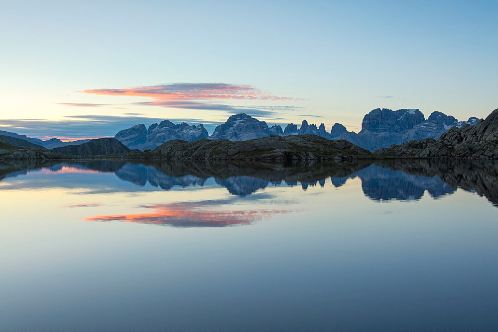 Blue sky and pink clouds reflected in Lago Nero at dawn, Cornisello Pinzolo, Brenta Dolomites, Trentino-Alto Adige, Italy, Europe