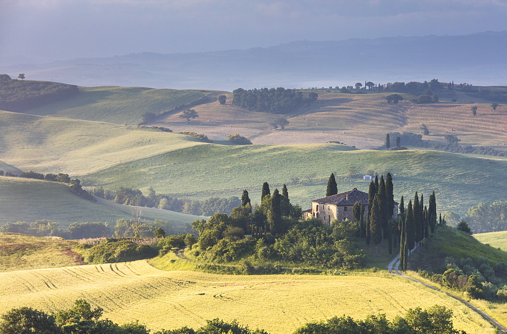 Sunrise on the gentle green hills and typical farm house of Val d'Orcia, UNESCO World Heritage Site, Province of Siena, Tuscany, Italy, Europe