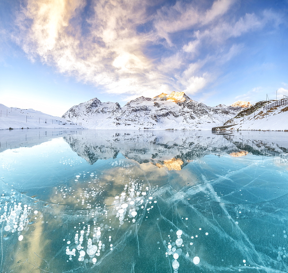 Panorama of ice bubbles and frozen surface of Lago Bianco at dawn, Bernina Pass, canton of Graubunden, Engadine, Switzerland, Europe