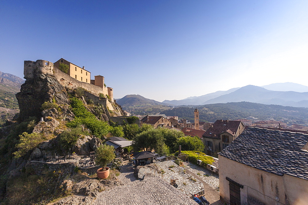 View of the old town of citadel of Corte perched on the hill surrounded by mountains, Haute-Corse, Corsica, France, Europe