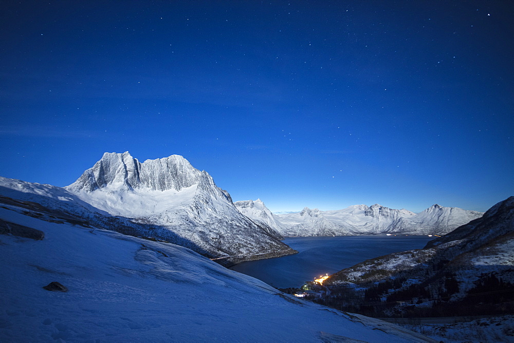 Stars of the polar night on the Senjahopen peak and frozen sea, Senja, Mefjordbotn, Troms county, Norway, Scandinavia, Europe