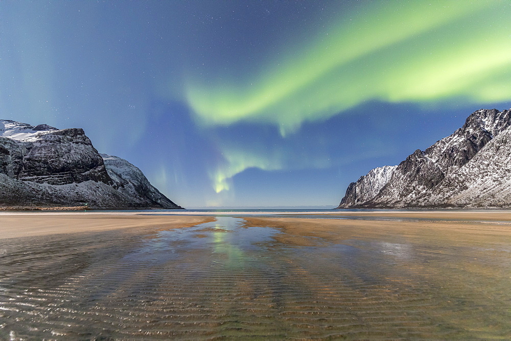 Sandy beach and snowy peaks framed by the Northern Lights (aurora borealis) in the polar night, Ersfjord, Senja, Troms, Norway, Scandinavia, Europe