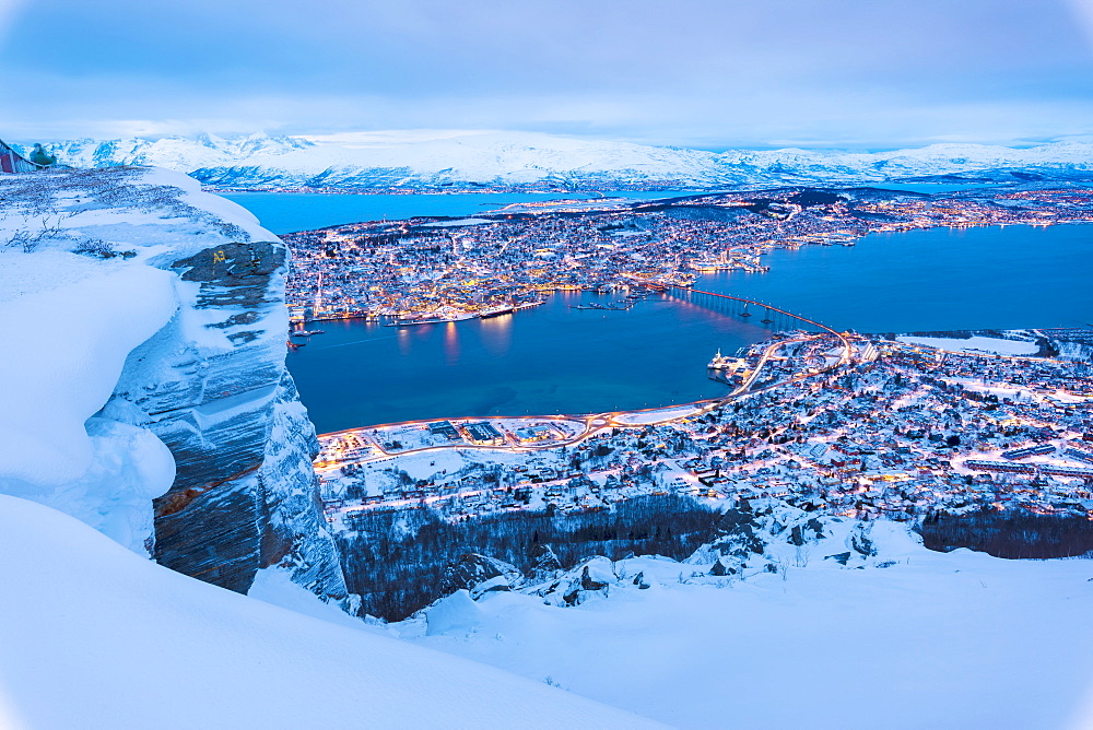 View of the city of Tromso at dusk from the mountain top reached by the Fjellheisen cable car, Troms, Northern Norway, Scandinavia, Europe