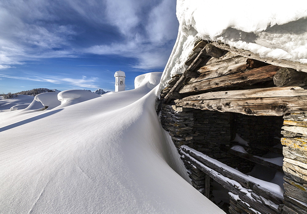 A mountain hut emerging from thick snow after a heavy snowfall in the Alpe Scima, Valchiavenna, Lombardy, Italy, Europe