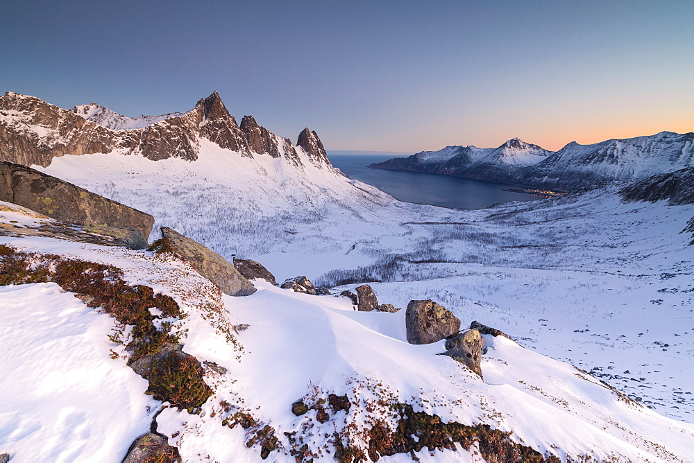 View of the village of Husoy and icy sea along the Oyfjorden from peak Hesten at dawn, Lenvik, Senja, Troms, Norway, Scandinavia, Europe