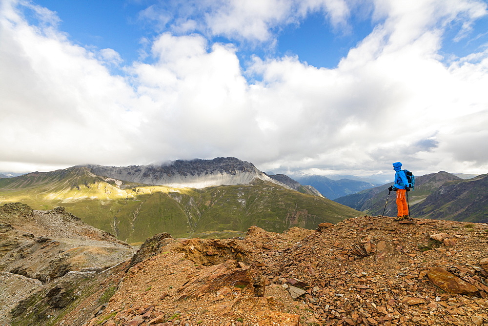 Hiker on the war trenches on rocky peaks, Filon Del Mott, Bormio, Braulio Valley, Stelvio Pass, Valtellina, Lombardy, Italy, Europe