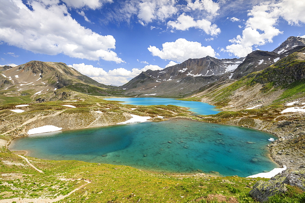 Clouds and sun on turquoise lakes framed by rocky peaks, Joriseen, Jorifless Pass, canton of Graubunden, Engadine, Switzerland, Europe