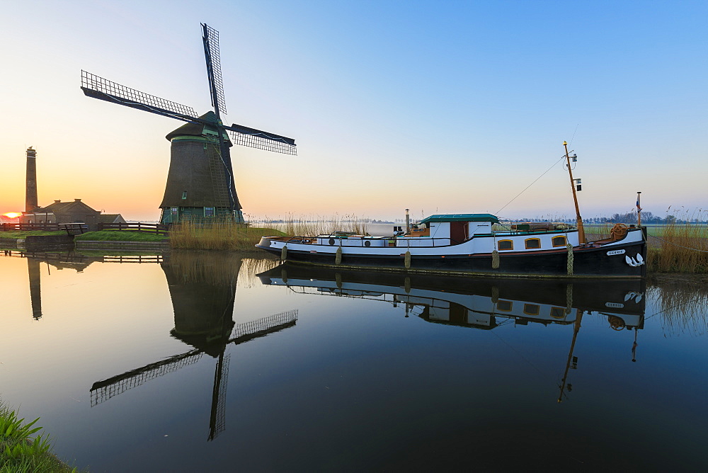 Typical windmill reflected in the canal at dawn, Berkmeer, municipality of Koggenland, North Holland, The Netherlands, Europe