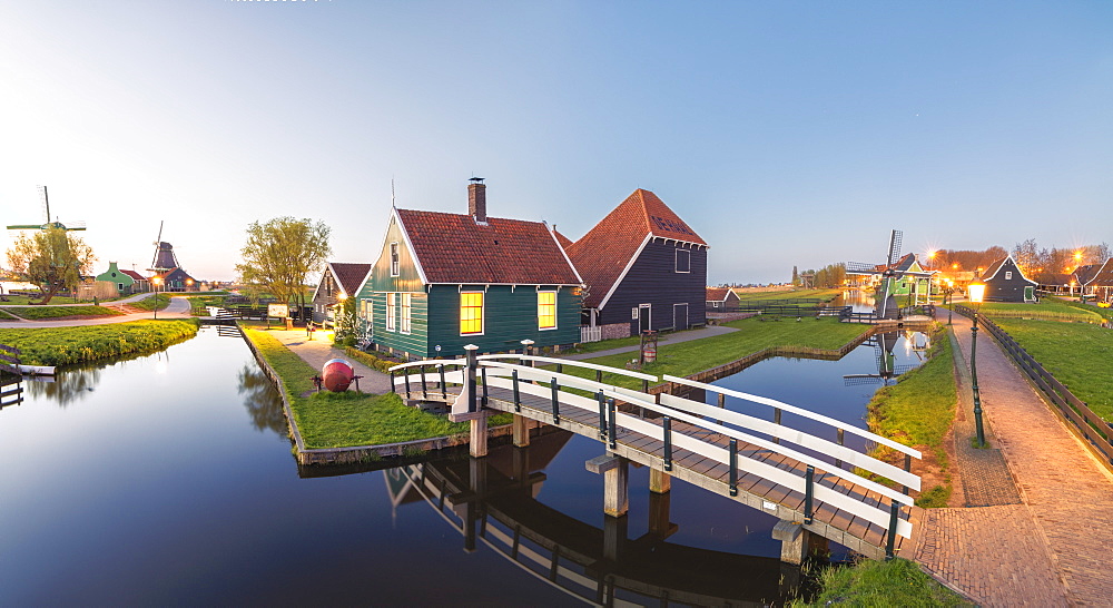 Panorama of wooden houses and windmills of the typical village of Zaanse Schans at dusk, North Holland, The Netherlands, Europe