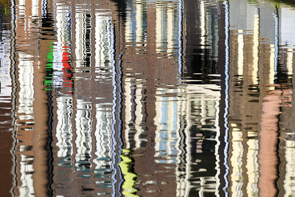 Abstract details of buildings reflected in a typical canal of the river Amstel, Amsterdam, Holland (The Netherlands), Europe