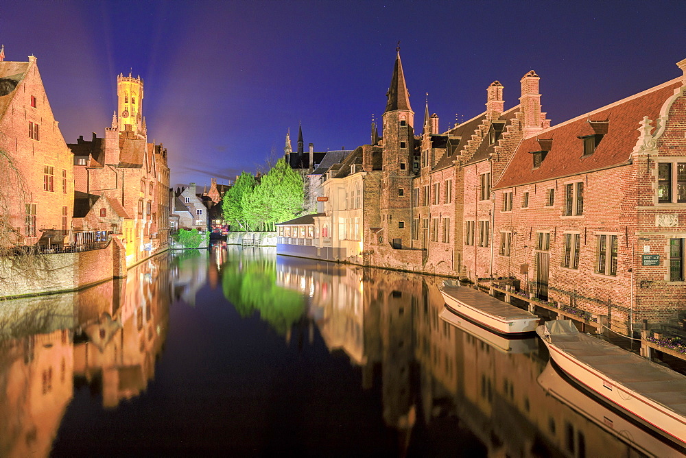 The medieval Belfry and historic buildings are reflected in Rozenhoedkaai canal at night, UNESCO World Heritage Site, Bruges, West Flanders, Belgium, Europe