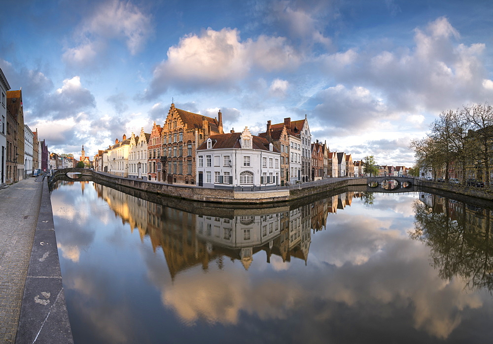 Pink clouds at dawn on the Belfry and historic buildings reflected in the typical canal, Bruges, West Flanders, Belgium, Europe