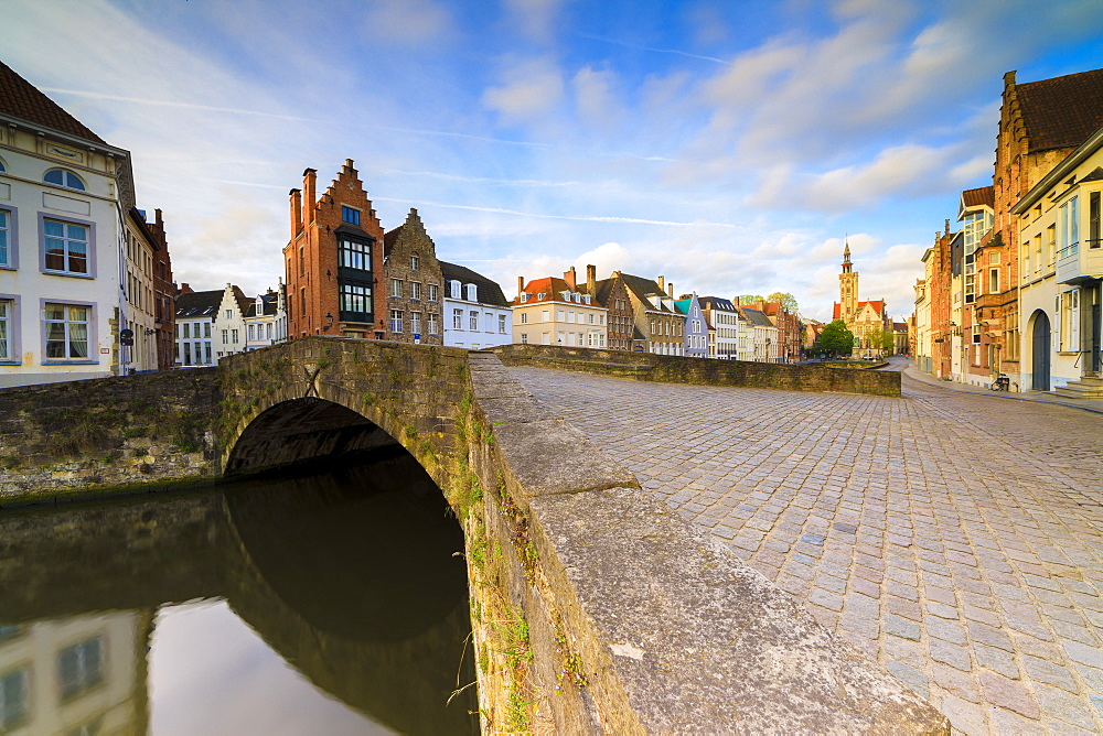 Pink clouds at dawn on the typical buildings and quay along the typical canal, Bruges, West Flanders, Belgium, Europe