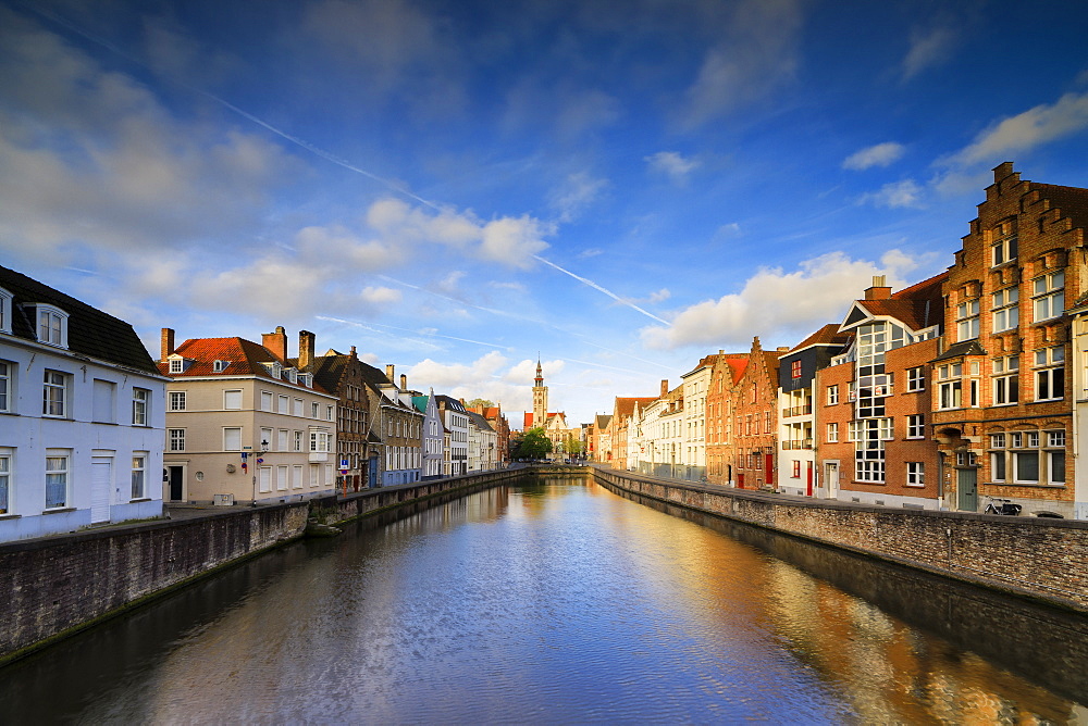 Bright sky at dawn on historic buildings and houses of city centre reflected in the canal, Bruges, West Flanders, Belgium, Europe