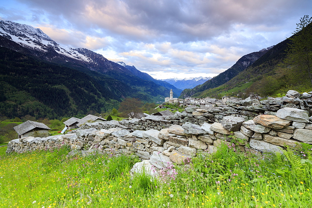 Pink clouds at dawn on the alpine village of Soglio, Maloja, Bregaglia Valley, Engadine, Canton of Graubunden, Switzerland, Europe