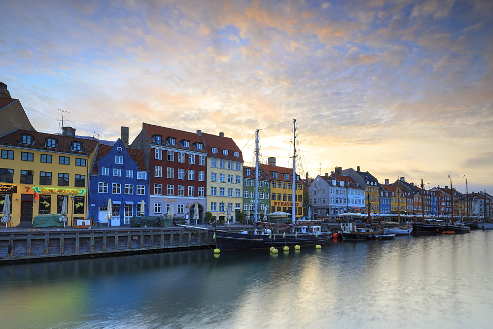 Sunrise on the colourful facades along the harbour in the district of Nyhavn, Copenhagen, Denmark, Europe