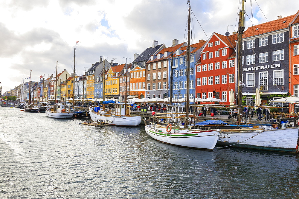 Colourful facades and typical boats along the canal and entertainment district of Nyhavn, Copenhagen, Denmark, Europe