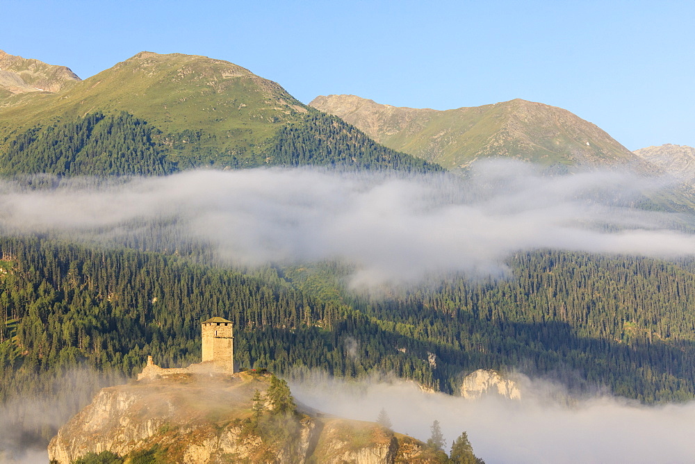 Tower of Steinsberg Castle framed by woods, Ardez, canton of Graub?nden, district of Inn, lower Engadine, Switzerland, Europe