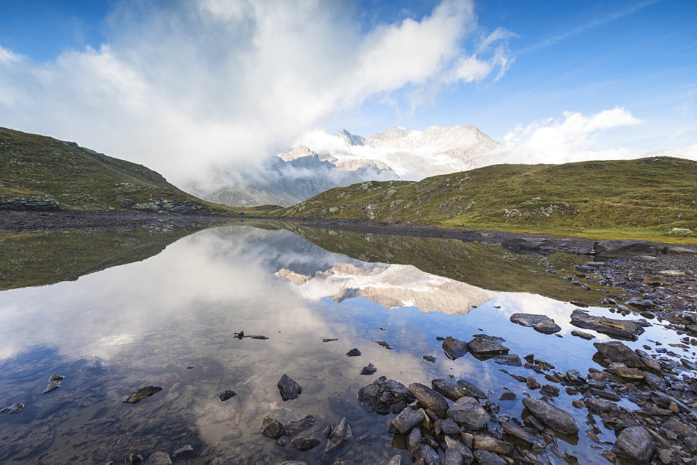 Piz Arlas, Cambrena, Caral reflected in lake, Bernina Pass, Poschiavo Valley, Engadine, Canton of Graubunden, Switzerland, Europe