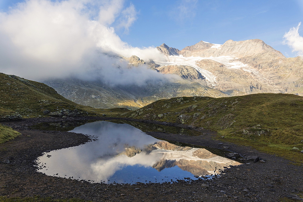 Piz Arlas, Cambrena, Caral reflected in water, Bernina Pass, Poschiavo Valley, Engadine, Canton of Graubunden, Switzerland, Europe