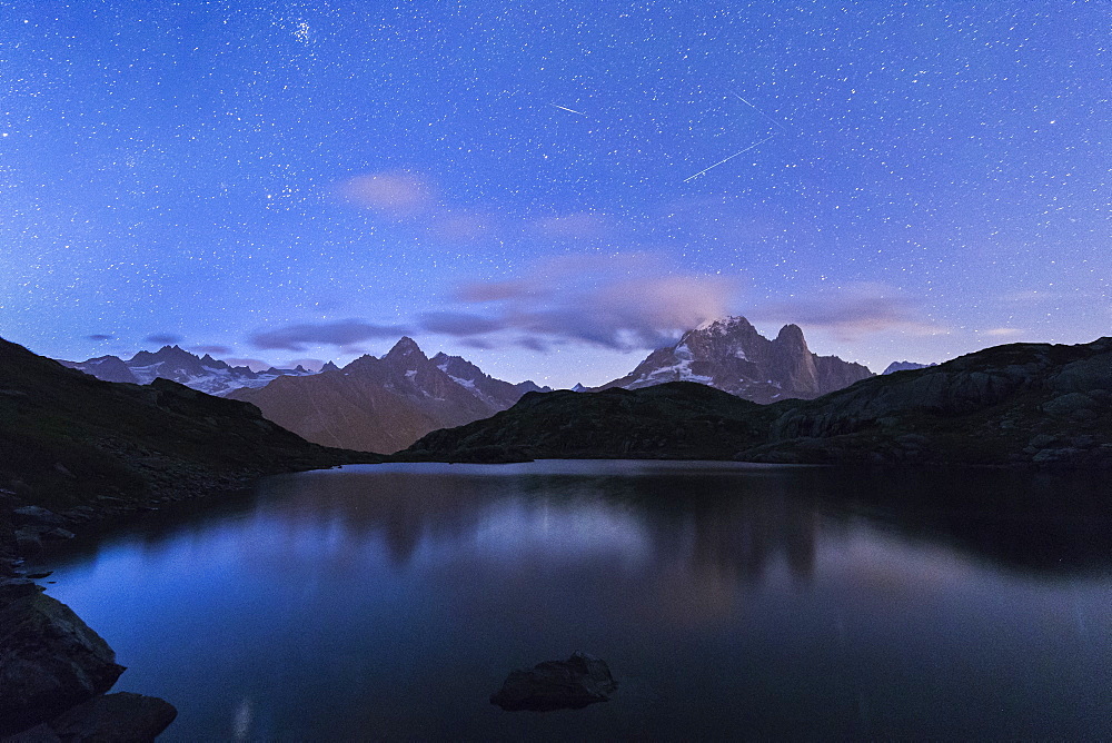 Shooting stars on the rocky peaks of Les Drus and Aiguille Verte, Lacs De Cheserys, Chamonix, Haute Savoie, French Alps, France, Europe