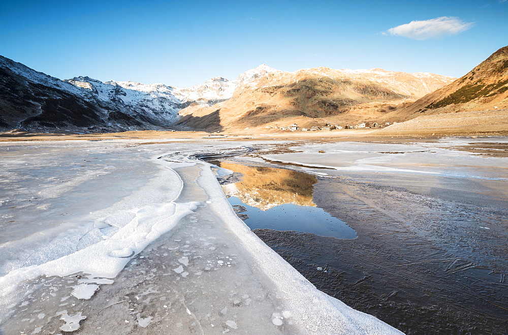 Frozen lake Montespluga at dawn, Chiavenna Valley, Sondrio province, Valtellina, Lombardy, Italy, Europe